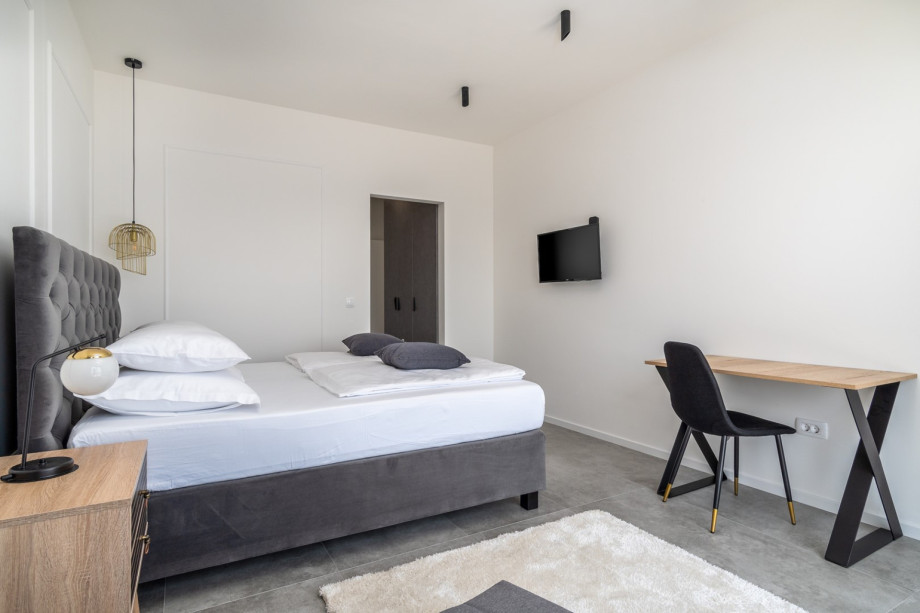Bedroom No2 also offers a TV, an A/C, and a balcony with sea views